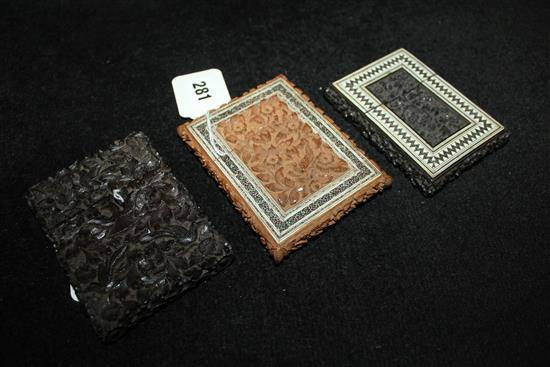 Two Indian carved and Sadali-inlaid wooden card cases & another carved all over with birds among foliage